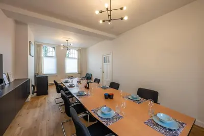 a dining room with a long table and chairs at Temse city center in Temse