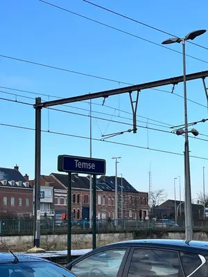 a sign for a car dealership in a parking lot at Temse city center in Temse