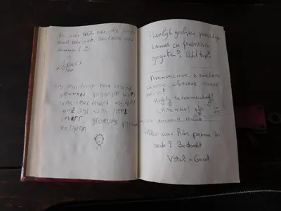 an open book with handwriting on the pages at Hotel Golden Dragon in Dessel