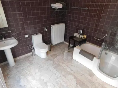 a bathroom with a tub and a toilet and a sink at Hotel Golden Dragon in Dessel