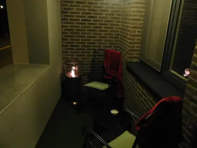 a dark room with a chair and a window at Hotel Golden Dragon in Dessel