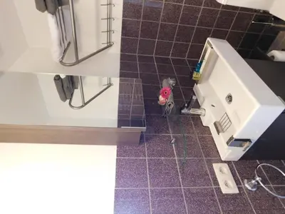a bathroom with a sink and a tile floor at Hotel Golden Dragon in Dessel