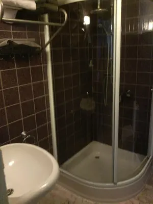 a bathroom with a shower with a glass door at Hotel Golden Dragon in Dessel