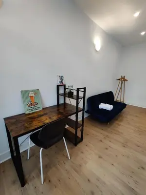 a room with a wooden table and a chair at Nice Flat Grand Place in Brussels