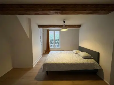 a bedroom with a bed and a window at Nice Flat Grand Place in Brussels