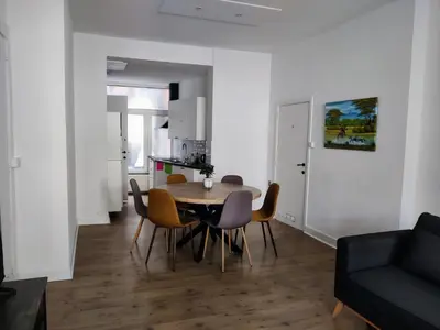a dining room and living room with a table and chairs at Nice Flat Grand Place in Brussels