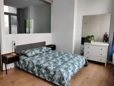 a bedroom with a bed and a dresser and a mirror at Nice Flat Grand Place in Brussels