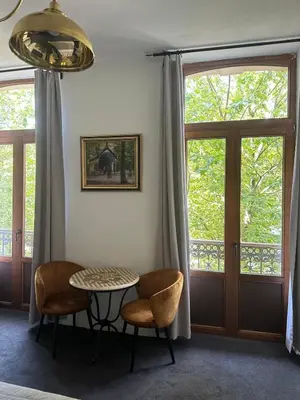 a room with a table and two chairs and windows at Happy Home in Brussels