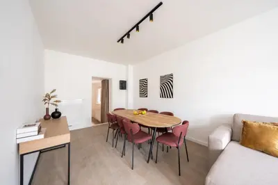 a living room with a table and chairs and a couch at Spacious City Getaway for 8 in Antwerp in Antwerp