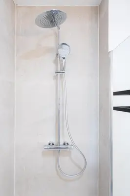 a shower with a shower head on a wall at Spacious City Getaway for 8 in Antwerp in Antwerp