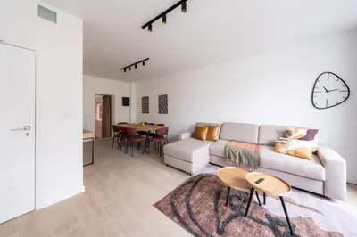 a living room with a couch and a table at Spacious City Getaway for 8 in Antwerp in Antwerp