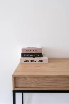 a stack of books sitting on top of a table at Spacious City Getaway for 8 in Antwerp in Antwerp
