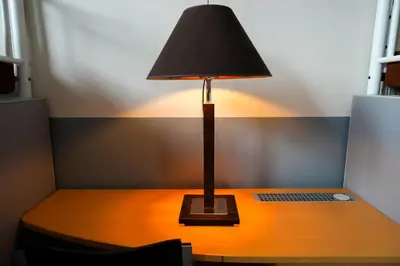 a lamp sitting on top of a desk with a laptop at YOUR HOSTEL midi station in Brussels