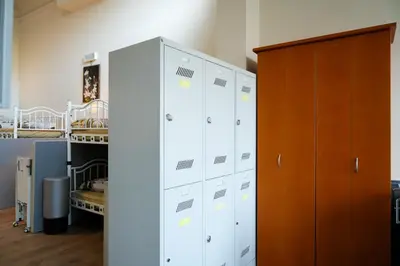 a room with white cabinets and a bed at YOUR HOSTEL midi station in Brussels
