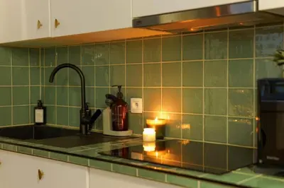 a kitchen with a sink with a candle on the counter at Charming home by Grote Markt with Free Parking in Antwerp