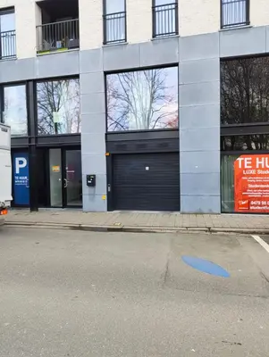 a building with two garage doors on a street at Charming home by Grote Markt with Free Parking in Antwerp
