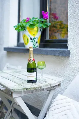 a bottle of wine and a glass on a table at Charming home by Grote Markt with Free Parking in Antwerp