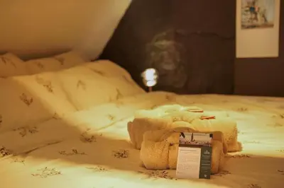 a bed with a stuffed animal on top of it at Charming home by Grote Markt with Free Parking in Antwerp