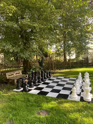 a chess board on the grass next to a bench at Memories in Assenede