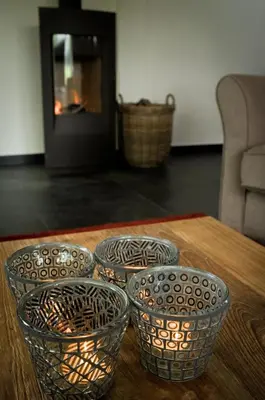 four bowls on a table in front of a fireplace at Geestmolenhof 1 in Holsbeek