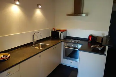 a small kitchen with a sink and a microwave at Geestmolenhof 1 in Holsbeek