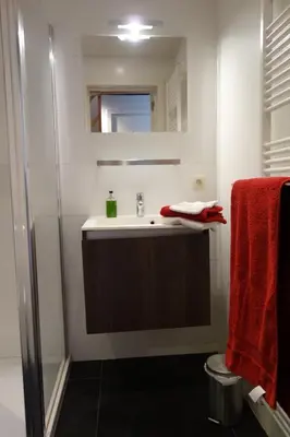 a bathroom with a sink and a shower at Geestmolenhof 1 in Holsbeek