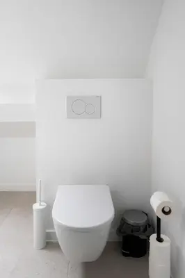 a bathroom with a white toilet in a room at Inviting 5-Person Duplex in Vibrant Antwerp in Antwerp