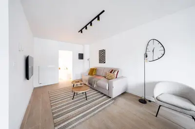 a living room with a couch and a chair at Inviting 5-Person Duplex in Vibrant Antwerp in Antwerp