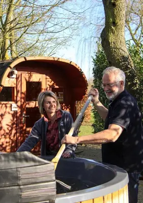 a man and a woman are in a ride in a toy train at B&B De Alffarhoeve in Hamme