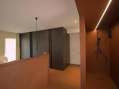 a hallway with dark wood cabinets and a staircase at B&B De Alffarhoeve in Hamme