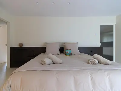 a large white bed with two pillows on it at B&B De Alffarhoeve in Hamme