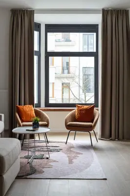 a living room with two chairs and a table at Inviting and bright 7-Person Apartment in Antwerp in Antwerp