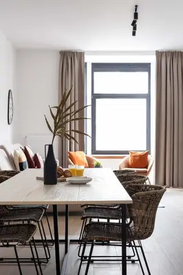 a living room with a table and chairs at Inviting and bright 7-Person Apartment in Antwerp in Antwerp