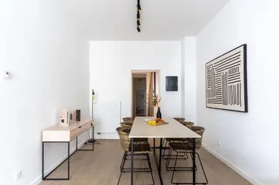 a kitchen and dining room with a table and chairs at Inviting and bright 7-Person Apartment in Antwerp in Antwerp