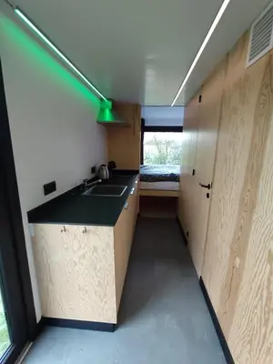 a small kitchen with a sink and a counter top at Kromven Puur Genieten in Merksplas