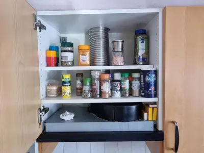 a cupboard filled with lots of condiments at Appartement Ruggeveld in Antwerp