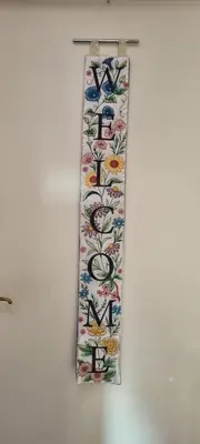 a towel hanging on a wall with flowers on it at Appartement Ruggeveld in Antwerp