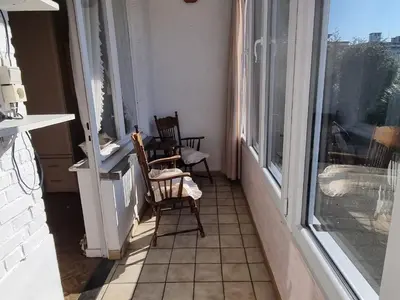 an empty room with two chairs and a window at Appartement Ruggeveld in Antwerp