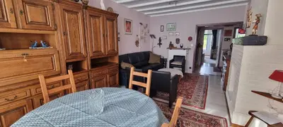 a living room with a table and a couch at Appartement Ruggeveld in Antwerp