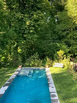 a swimming pool in the yard of a house at Superb house in absolute calm in Linkebeek