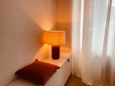 a lamp sitting on a table next to a window at Bohémien garden room in Ghent