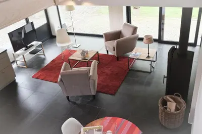 a living room with chairs and a red rug at Geestmolenhof 2 in Holsbeek