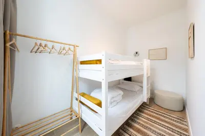a bathroom with white shelves in a room at Comfortable Urban Retreat for 6 in Central Antwerp in Antwerp