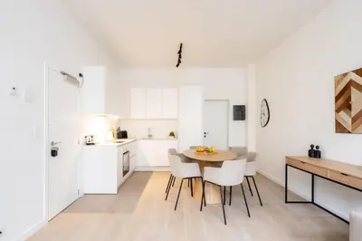 a kitchen and dining room with a table and chairs at Comfortable Urban Retreat for 6 in Central Antwerp in Antwerp