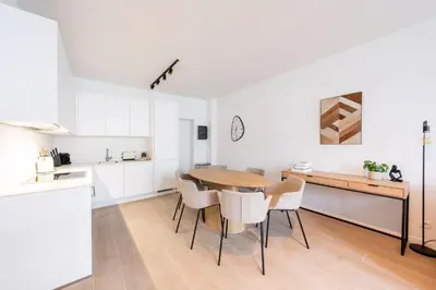 a kitchen and dining room with a table and chairs at Modern 6-Guest Apartment in Central Antwerp in Antwerp