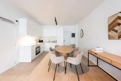 a kitchen and dining room with a table and chairs at Modern 6-Guest Apartment in Central Antwerp in Antwerp