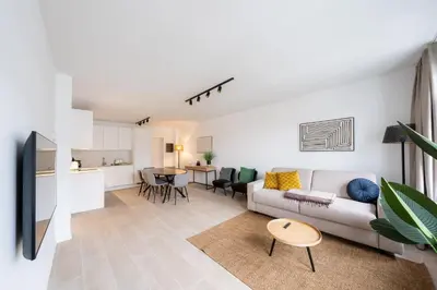 a living room with a couch and a table at Stylish Duplex for 8 in Central Antwerp in Antwerp