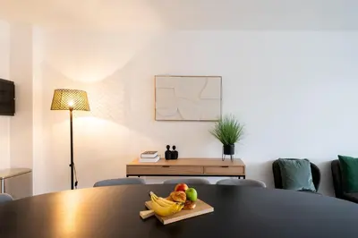a table with a bowl of fruit on it at Stylish Duplex for 8 in Central Antwerp in Antwerp