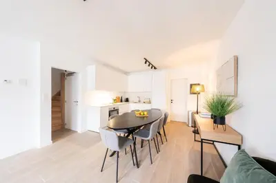 a dining room and kitchen with a table and chairs at Stylish Duplex for 8 in Central Antwerp in Antwerp