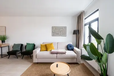 a living room with a couch and a table at Stylish Duplex for 8 in Central Antwerp in Antwerp